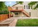 The home's backyard features a tiered deck, green lawn, and a garden bed at 1477 Serene Dr, Erie, CO 80516