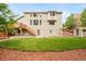 The home's backyard features a tiered deck, green lawn, and a storage shed at 1477 Serene Dr, Erie, CO 80516