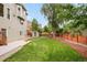 The home's backyard features a green lawn, mature trees, and a storage shed at 1477 Serene Dr, Erie, CO 80516