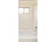 This bathroom features tile walls, a window with blinds, and a chrome faucet at 1477 Serene Dr, Erie, CO 80516