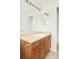 Bathroom featuring a single vanity with wood cabinets, a neutral countertop, and modern fixtures at 1477 Serene Dr, Erie, CO 80516