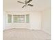Spacious bedroom with neutral carpet, bay window, and ceiling fan at 1477 Serene Dr, Erie, CO 80516