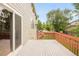 An outdoor deck features wood railings and a sliding glass door to the home's interior at 1477 Serene Dr, Erie, CO 80516