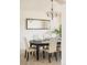 Formal dining room with decorative mirror and contemporary lighting at 1477 Serene Dr, Erie, CO 80516