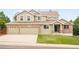 Charming two-story home with a brick and siding exterior and a spacious three-car garage at 1477 Serene Dr, Erie, CO 80516