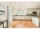 Spacious kitchen featuring wooden floors, modern appliances and lots of natural light at 1477 Serene Dr, Erie, CO 80516