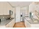 Contemporary kitchen with stainless steel appliances, shaker cabinets, and an island with counter seating at 1477 Serene Dr, Erie, CO 80516