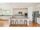 Kitchen featuring stainless steel appliances, shaker cabinets, and an island with bar seating at 1477 Serene Dr, Erie, CO 80516