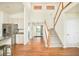 Open concept living room with kitchen and staircase to the second level at 1477 Serene Dr, Erie, CO 80516
