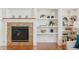Cozy living room with a fireplace and built-in shelving showcasing decorative items at 1477 Serene Dr, Erie, CO 80516