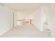 Carpeted loft area with natural light and an open layout, connecting different parts of the home at 1477 Serene Dr, Erie, CO 80516