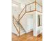 Staircase with hardwood floors and white-painted risers and wood banisters, offering a view of the second floor at 1477 Serene Dr, Erie, CO 80516
