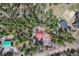 An aerial view captures multiple houses nestled among dense trees at 9530 Aspen Ln, Conifer, CO 80433