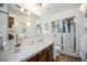Clean bathroom with wooden vanity, granite countertop, and glass-enclosed shower at 9530 Aspen Ln, Conifer, CO 80433