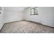 Cozy bedroom featuring carpet, window, and baseboard heating at 9530 Aspen Ln, Conifer, CO 80433