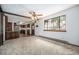 Bright living room with wood beam, seamless flow into kitchen, and large window to the outdoors at 9530 Aspen Ln, Conifer, CO 80433