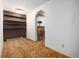Open living room with dark brown shelving, a bar, and neutral carpet at 9530 Aspen Ln, Conifer, CO 80433