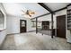Open-concept living room with wood beams, fireplace, and windows showcasing natural light and views at 9530 Aspen Ln, Conifer, CO 80433