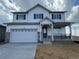 Charming two-story home with a two-car garage and a welcoming front porch at 2145 S Ider Way, Aurora, CO 80018