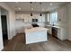 Modern kitchen with white cabinets, a center island, and stainless steel appliances at 2145 S Ider Way, Aurora, CO 80018