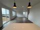 Open-concept living room with hardwood floors, bright lighting and sliding glass doors to the yard at 2145 S Ider Way, Aurora, CO 80018