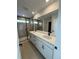 Modern main bathroom with double sinks, a large mirror, and a walk-in shower at 2145 S Ider Way, Aurora, CO 80018