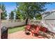 Landscaped backyard featuring a patio with seating, lawn area, and mature trees, ideal for outdoor relaxation at 12411 Irving Dr, Broomfield, CO 80020