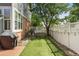 Private backyard featuring artificial turf, white picket fence, and lush greenery, creating a serene outdoor space at 12411 Irving Dr, Broomfield, CO 80020