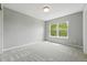 Bright bedroom with neutral carpet and paint and a large window with tree views at 12411 Irving Dr, Broomfield, CO 80020