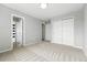 Neutral bedroom with plush carpet, spacious closet, and accessible doorways at 12411 Irving Dr, Broomfield, CO 80020