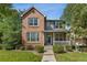 Attractive two-story home boasting a brick and siding facade, manicured lawn, and welcoming porch at 12411 Irving Dr, Broomfield, CO 80020