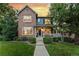 Charming two-story home with brick and siding exterior, landscaped yard, and inviting front porch at 12411 Irving Dr, Broomfield, CO 80020