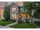 Charming two-story home with brick and siding, a well-manicured lawn and a cozy front porch at 12411 Irving Dr, Broomfield, CO 80020
