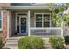 Inviting front porch with decorative wreath, hanging flower baskets and a seating area at 12411 Irving Dr, Broomfield, CO 80020