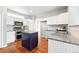 Well-equipped kitchen with white cabinets, stainless steel appliances, and a central island at 12411 Irving Dr, Broomfield, CO 80020