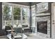 Comfortable living room with a stone fireplace, large windows, and stylish decor at 12411 Irving Dr, Broomfield, CO 80020