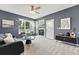 Inviting living room with a cozy fireplace and large windows providing ample natural light at 12411 Irving Dr, Broomfield, CO 80020