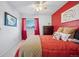 Bedroom with red accent wall and comfortable bed at 9292 W 98Th Way, Westminster, CO 80021