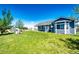 Large backyard with well-maintained lawn, playset, and comfortable covered porch at 59466 E Commanche Way, Strasburg, CO 80136