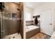 Modern bathroom with a glass-enclosed shower, soaking tub, and stylish tile work, creating a spa-like experience at 59466 E Commanche Way, Strasburg, CO 80136