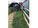Chicken coop, with flowers blooming nearby, surrounded by a wooden fence, offering a rustic charm at 59466 E Commanche Way, Strasburg, CO 80136