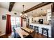 Cozy dining area featuring rustic wood accents, modern lighting, and a breakfast bar with seating at 59466 E Commanche Way, Strasburg, CO 80136