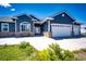 Beautiful home with a three-car garage, brick accents, and a well-manicured lawn, showcasing curb appeal at 59466 E Commanche Way, Strasburg, CO 80136