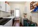 Functional laundry room with white cabinets, a utility sink, washer, and dryer, offering convenience and organization at 59466 E Commanche Way, Strasburg, CO 80136