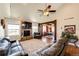 Open living room with fireplace, hardwood floors, and ample seating, perfect for gatherings at 59466 E Commanche Way, Strasburg, CO 80136