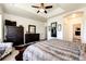 Large main bedroom featuring a sitting area, wood furniture, and an attached bathroom for ultimate convenience at 59466 E Commanche Way, Strasburg, CO 80136