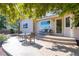 Charming backyard patio area shaded by mature tree featuring steps, seating, and privacy fence at 1376 Banner Cir, Erie, CO 80516
