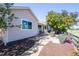 Exterior of home with cozy backyard patio area, flowers, and a walking path at 1376 Banner Cir, Erie, CO 80516