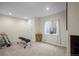 Basement area showcasing fitness equipment, bright lighting, and a large window at 1376 Banner Cir, Erie, CO 80516