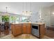 Bright kitchen features a center island with stainless steel appliances, with a cozy eating area and a view to the living room at 1376 Banner Cir, Erie, CO 80516